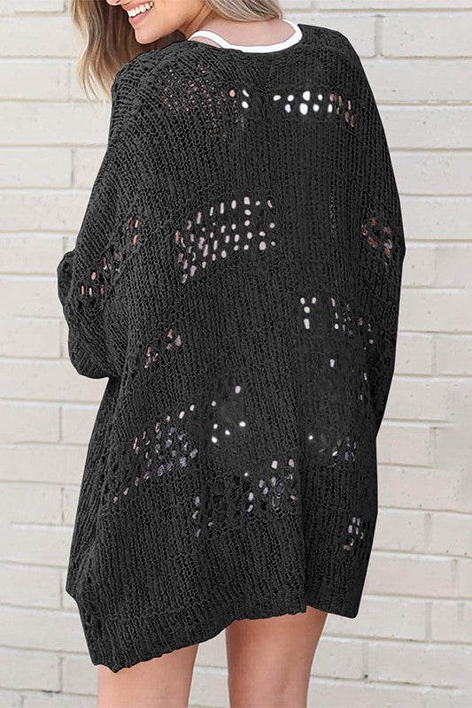 Shophouse Northwest black open knit crochet dolman sleeve cardigan shown from back on smiling model