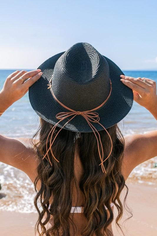 Shophouse Northwest straw panama fedora hat on woman at beach, back view, leather tie and long wavy hair