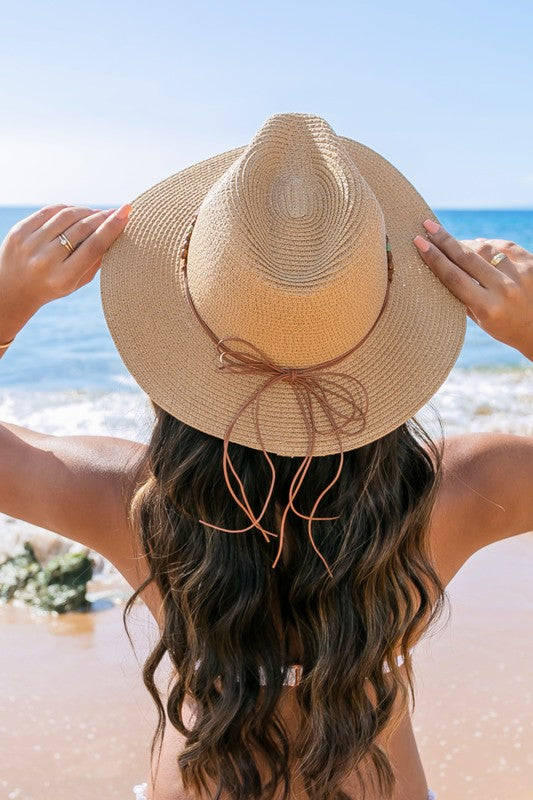 Shophouse Northwest straw panama fedora hat on woman at beach back view with wavy hair and leather tie