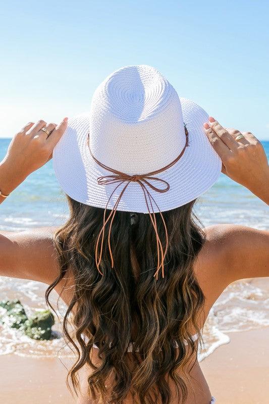 Shophouse Northwest straw panama fedora hat white woven beach hat with leather bow back view on woman at beach
