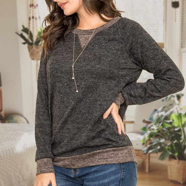 Shophouse Northwest plus size raglan tunic sweater charcoal layered hem and cuffs shown on model with jeans
