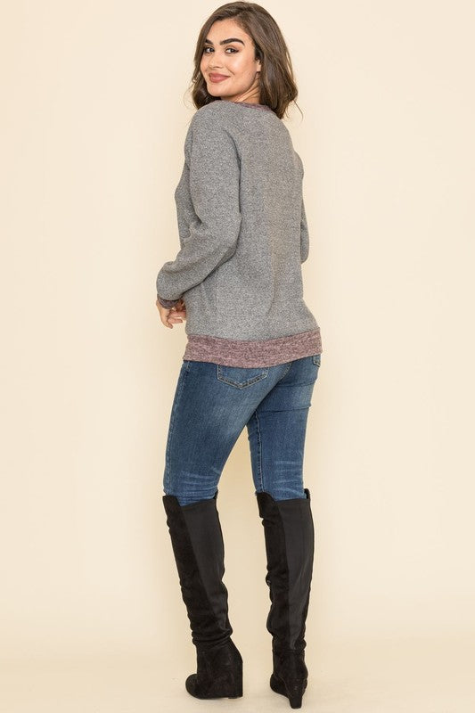 Shophouse Northwest plus size raglan tunic sweater gray with maroon hem modeled with jeans and black knee high boots