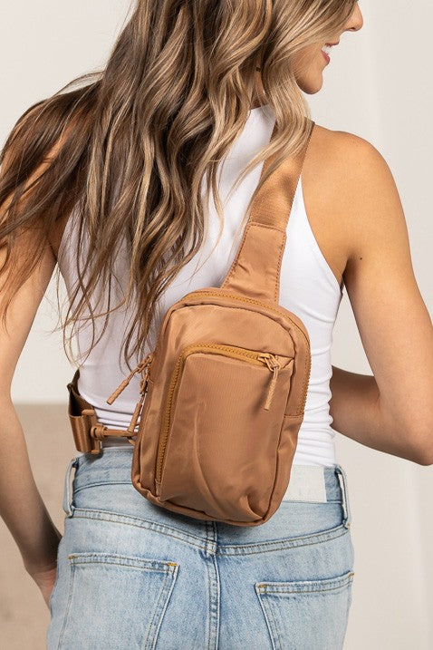 Shophouse Northwest nylon crossbody bag for women tan small zippered sling purse worn on model back
