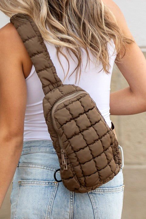 Skyler puffer sling bag Shophouse Northwest brown quilted crossbody worn over back with zipper pocket
