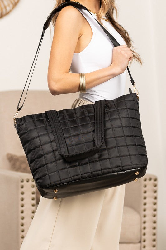 Shophouse Northwest black quilted travel tote bag with shoulder strap and gold hardware