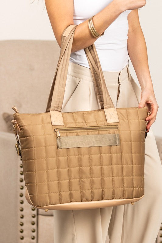 Shophouse Northwest quilted travel tote bag in tan with square quilting exterior zip pocket and long shoulder straps
