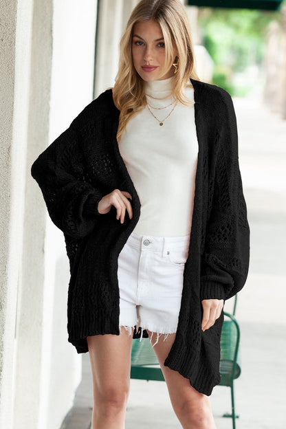 Shophouse Northwest black crochet dolman cardigan oversized open front with balloon sleeves white turtleneck and shorts