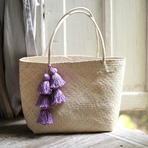 Borneo straw tote bag with purple tassels, perfect for beach trips or everyday use