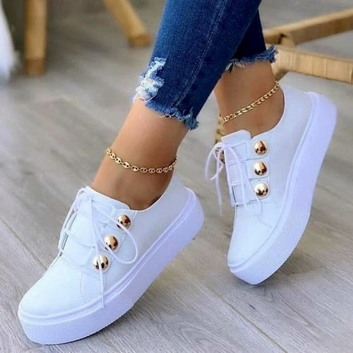 Stylish white casual breathable vulcanized running shoes with gold-tone eyelets for a modern look