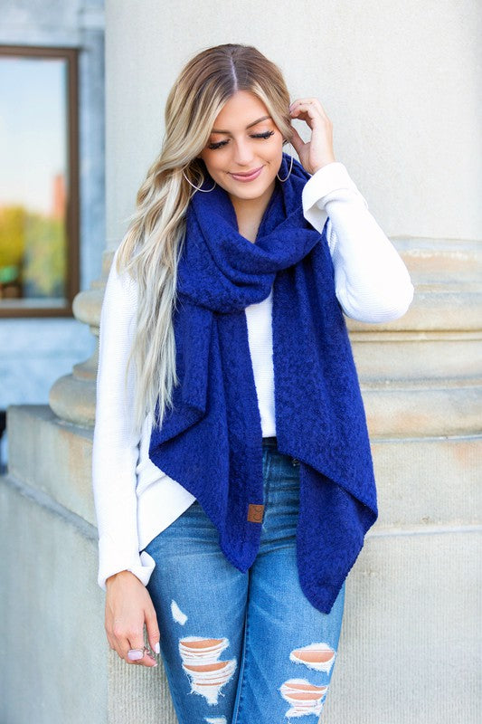 Shophouse Northwest model wearing navy blue cc cozy draped oversized scarves for women over white sweater and ripped jeans outdoors