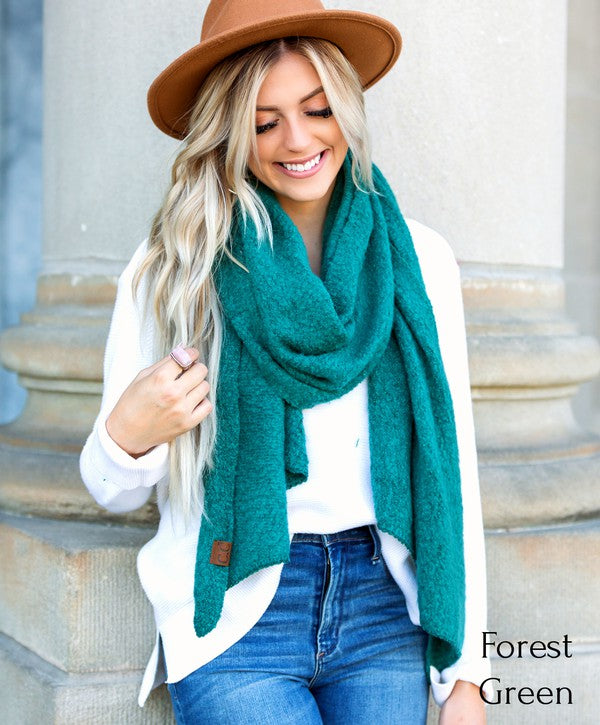 Shophouse Northwest model wearing forest green cc cozy draped oversized scarves for women over white sweater and jeans