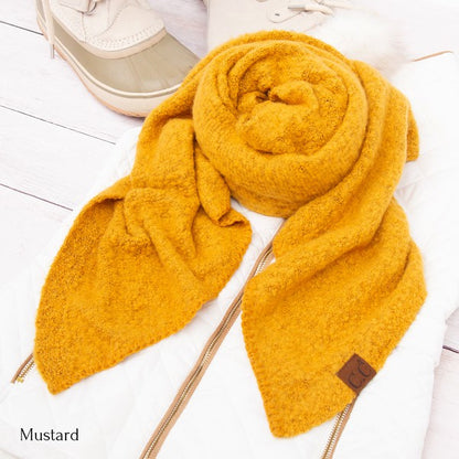 Mustard textured knit scarf styled on a white quilted jacket with boots cc cozy draped oversized scarves for women