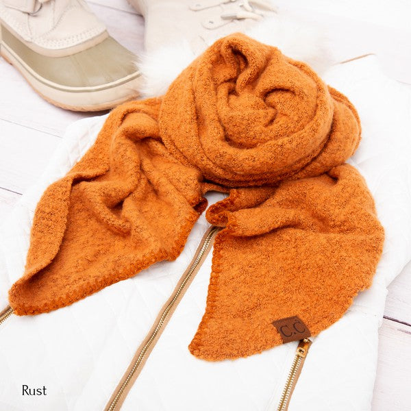 Rust fuzzy scarf with cc tag styled on white quilted jacket and boots cc cozy draped oversized scarves for women