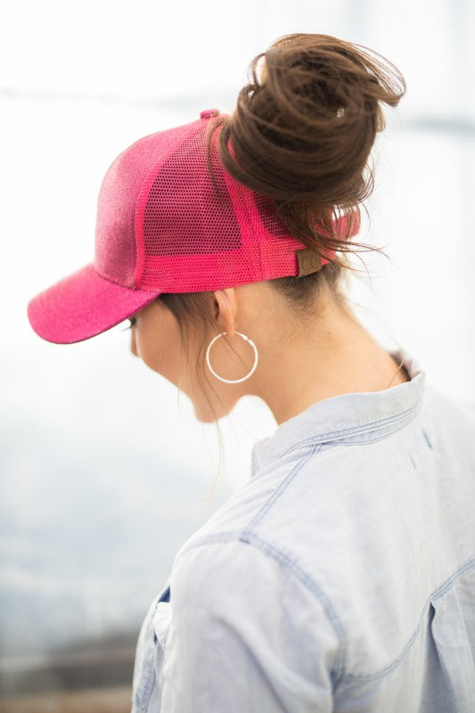 Shophouse Northwest CC glitter messy bun hat pink mesh cap worn by woman with high bun and hoop earrings