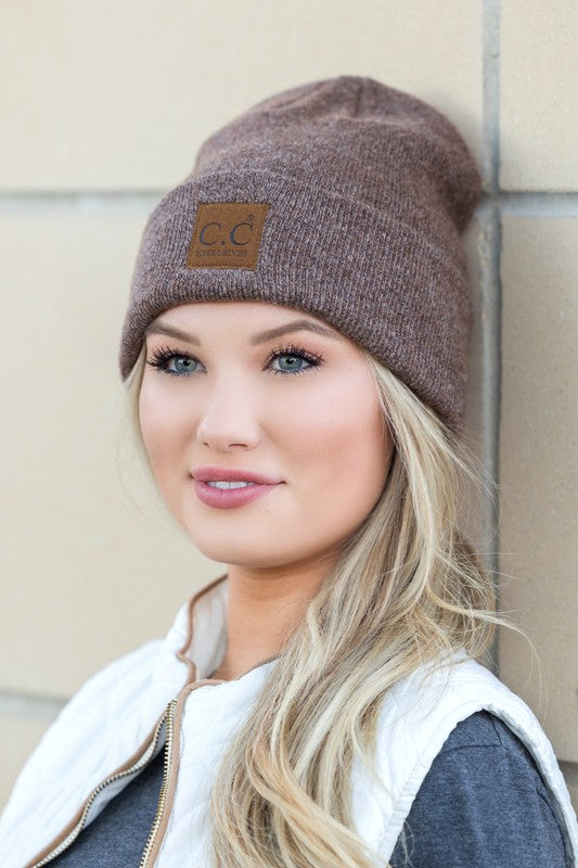 Model wearing CC heathered boyfriend beanie in brown with leather CC patch styled slouchy casual look
