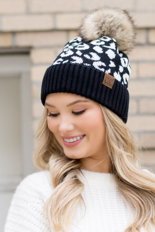 Shophouse Northwest leopard fur knit pom beanie black and white leopard pattern knit with faux fur pom on model