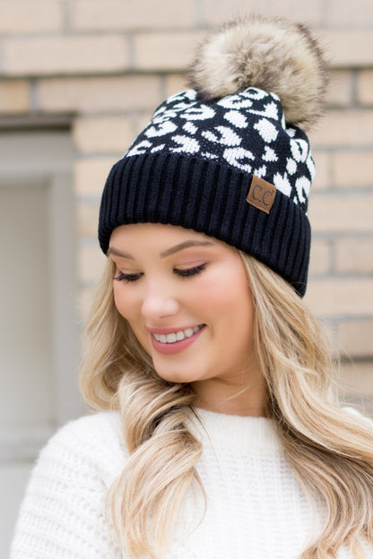 Shophouse Northwest leopard fur knit pom beanie black and white leopard pattern knit with faux fur pom on model