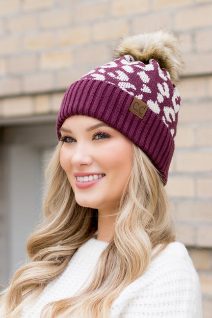 Shophouse Northwest maroon knit hat with white leopard pattern faux fur pom and leather tag leopard fur knit pom beanie