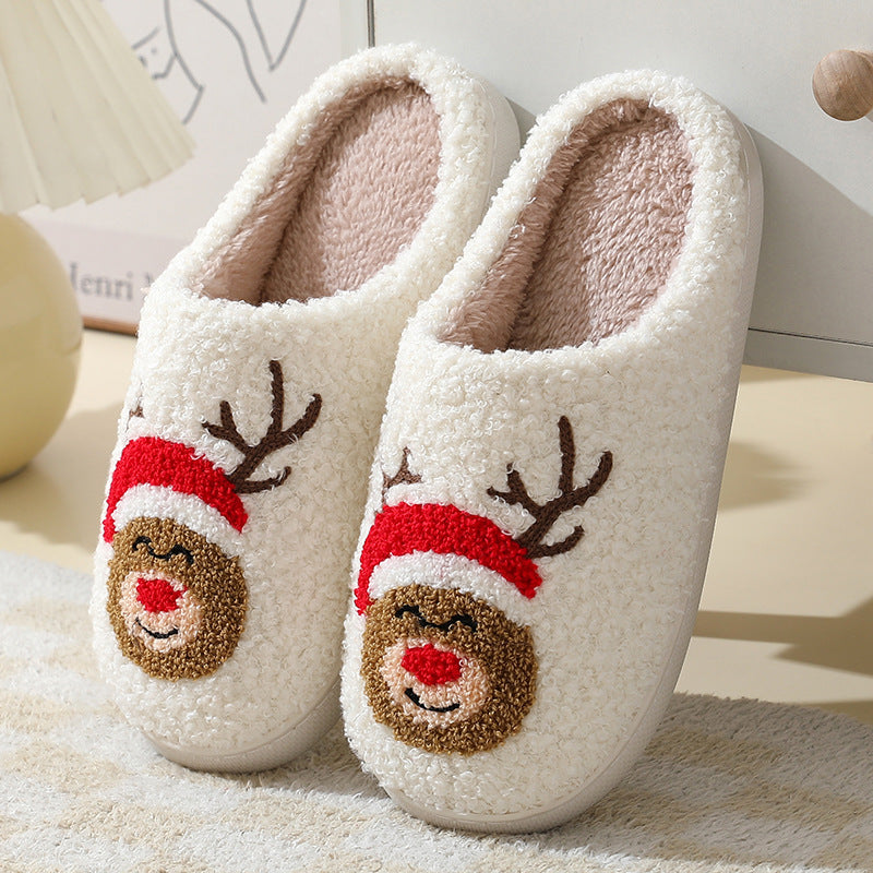 Cozy Christmas cartoon slippers featuring a reindeer design with a red hat and soft texture