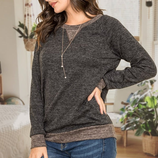 Shophouse Northwest plus size raglan tunic sweater charcoal layered hem and cuffs shown on model with jeans