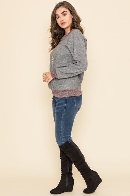 Shophouse Northwest wearing plus size raglan tunic sweater heather gray with mauve hem and black knee high boots
