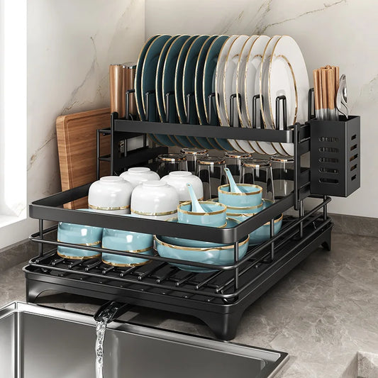 Double layer kitchen drying rack with plates, cups, and utensils organized in a modern kitchen setting