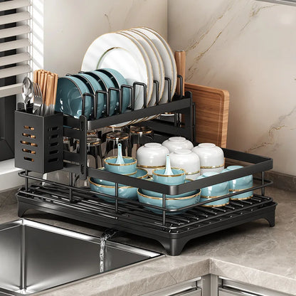 Double layer kitchen drying rack with plates, cups, and utensils drying on a stylish countertop