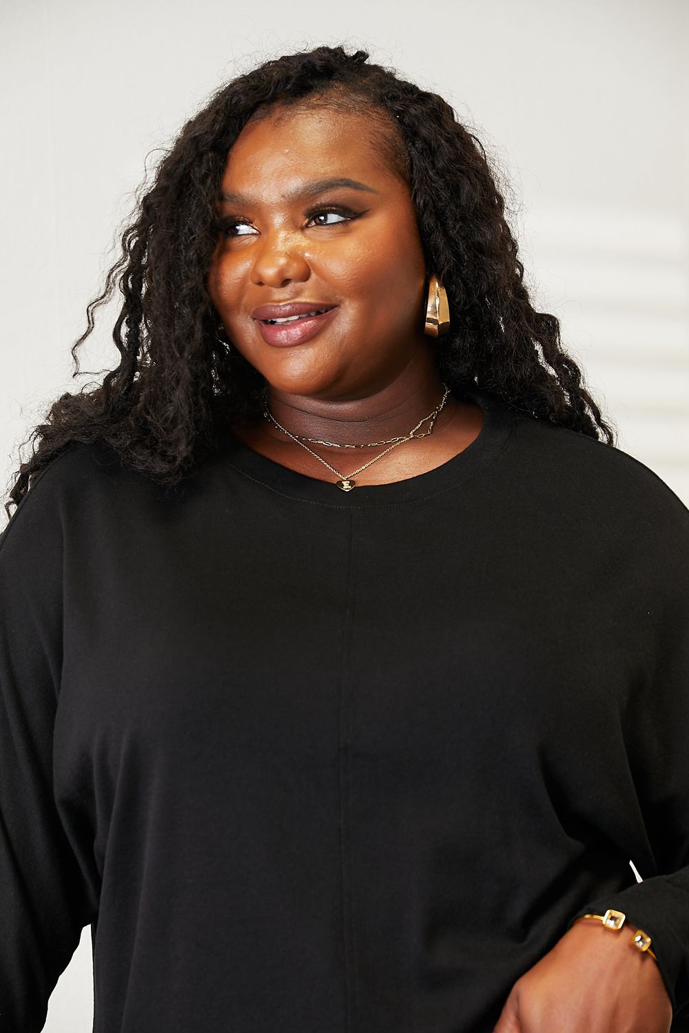 Trendsi double take seam detail top in black, featuring a relaxed fit and stylish design