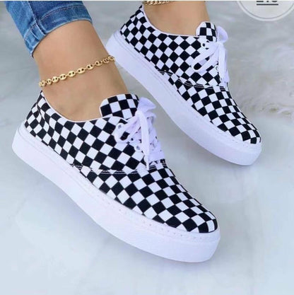 Fashion graffiti trainer sneakers in black and white checkered pattern with white soles