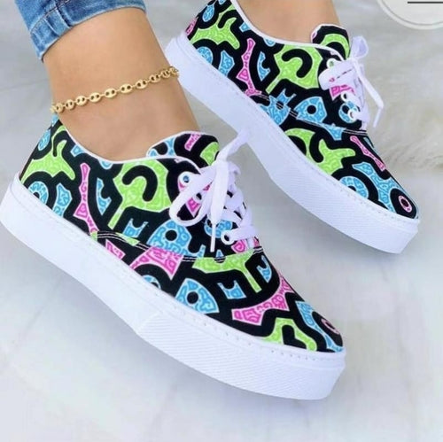 Fashion graffiti trainer sneakers in vibrant colors with unique patterns on a white sole