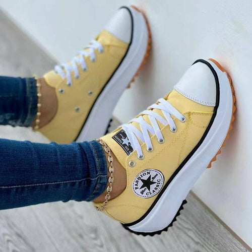 Yellow flat lace-up canvas sneakers with classic design and contrast sole for casual wear