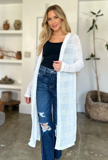 Trendsi full size cardigan sweater in white worn over a black tank top with distressed jeans