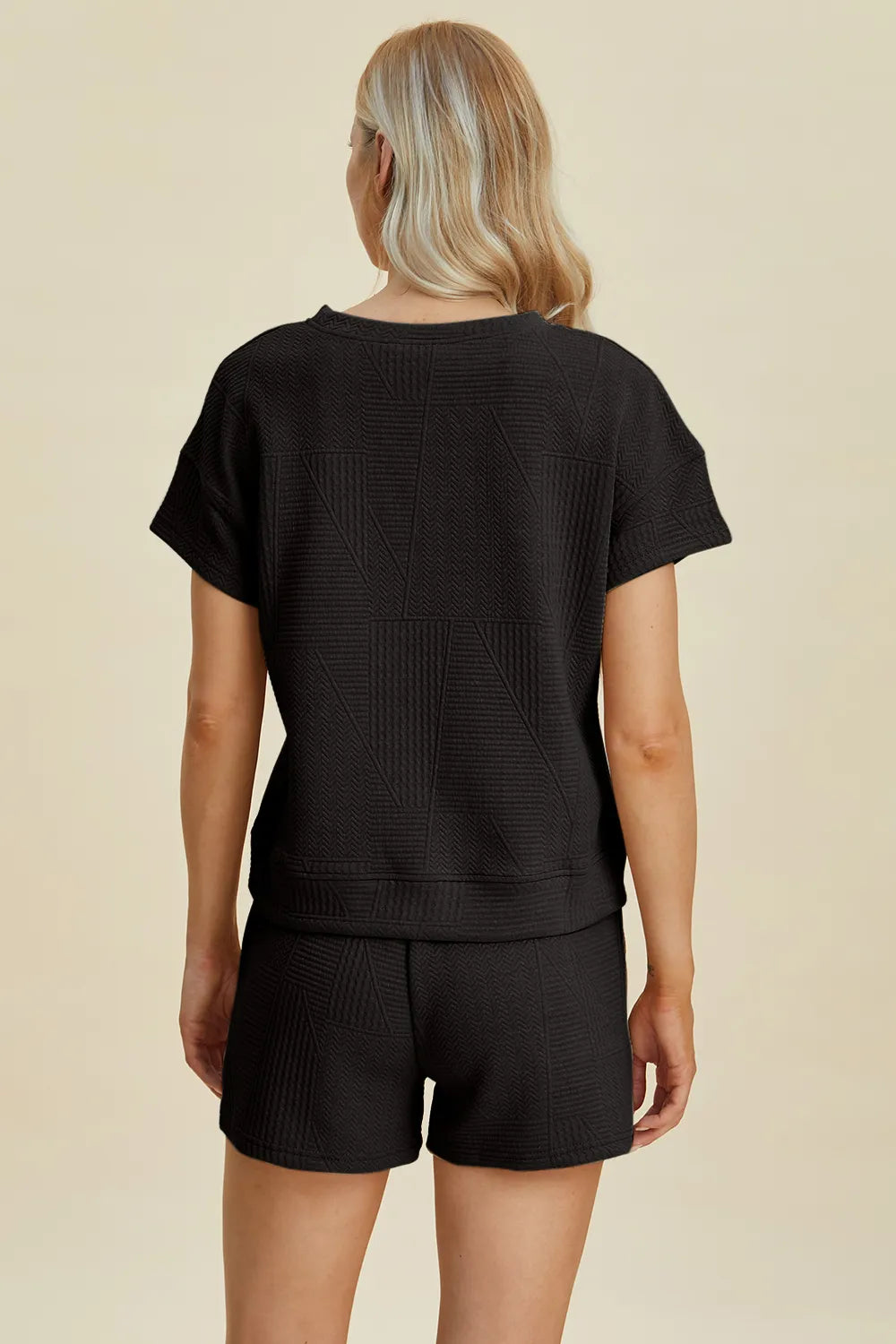 Trendsi full size textured short set in black featuring a relaxed fit and stylish design.