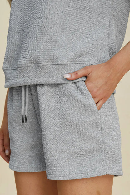 Trendsi full size textured short set in light gray, featuring a relaxed top and shorts with pockets