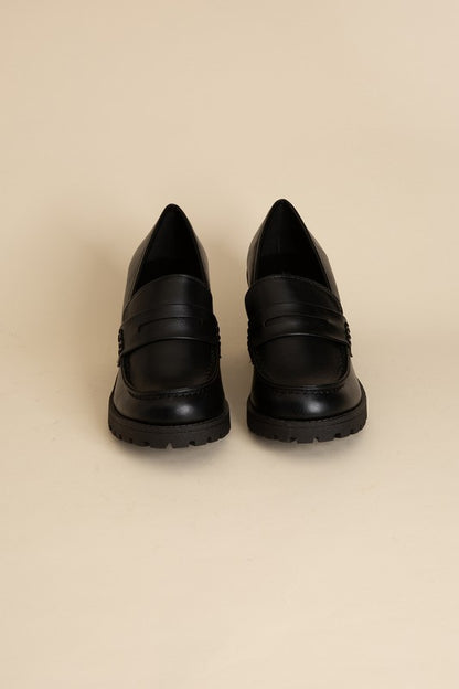 Shophouse Northwest black leather KINDER Loafer shoes front view with lug sole and penny strap on beige background