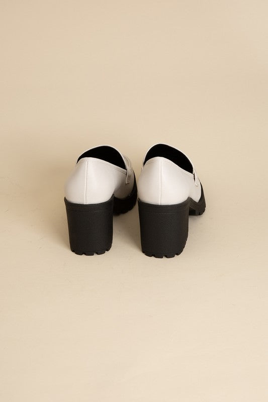 Shophouse Northwest KINDER Loafer shoes white leather loafers with chunky black block heels rear view on beige background