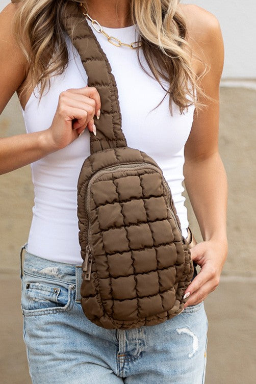 Skyler puffer sling bag by Shophouse Northwest brown quilted crossbody bag worn across torso