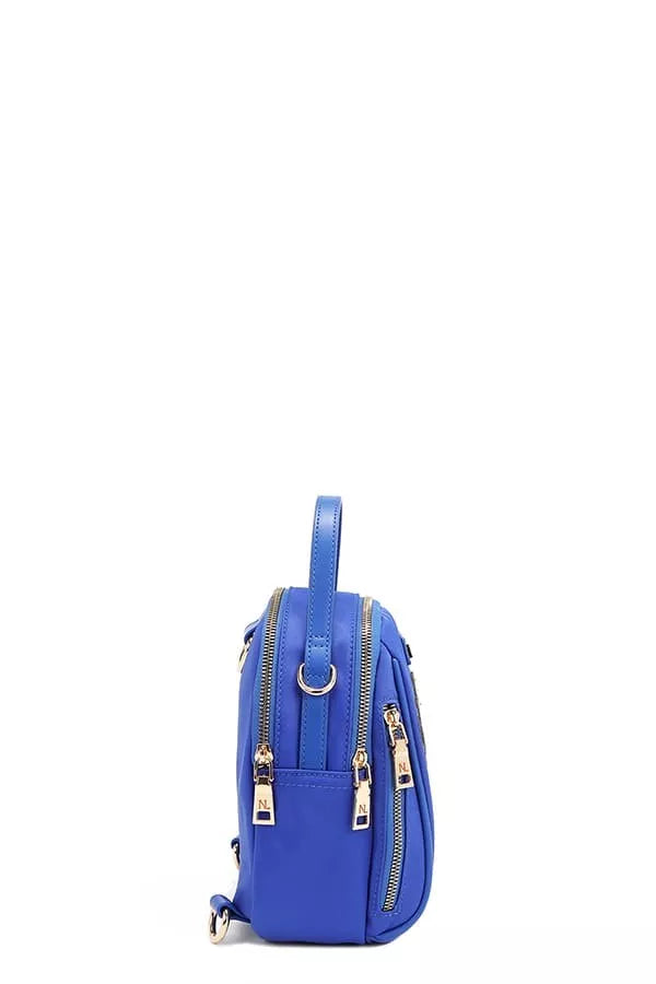 Nicole Lee color patch bag in vibrant blue with multiple zippers and a top handle
