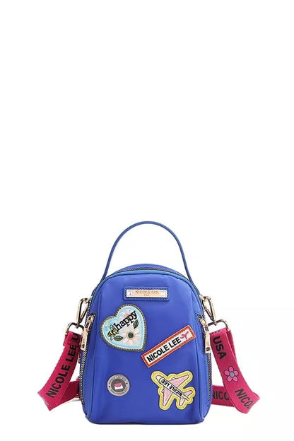 Nicole Lee color patch bag in blue with fun patches and pink straps for a trendy look