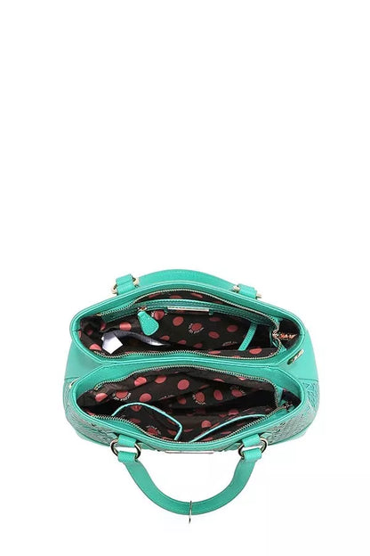 Interior view of Nicole Lee USA monogram handbag showcasing multiple compartments and a polka dot lining