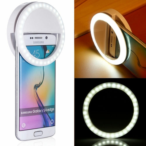 Portable selfie ring light clip attached to a smartphone for enhanced lighting in selfies