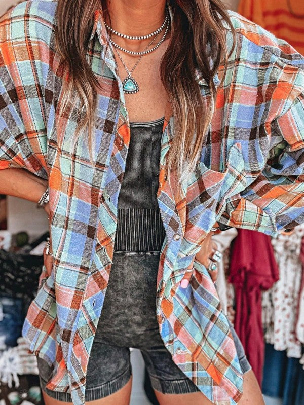 Shophouse Northwest cotton boho plaid shacket oversized orange blue plaid shirt worn open over black ribbed tank and biker shorts