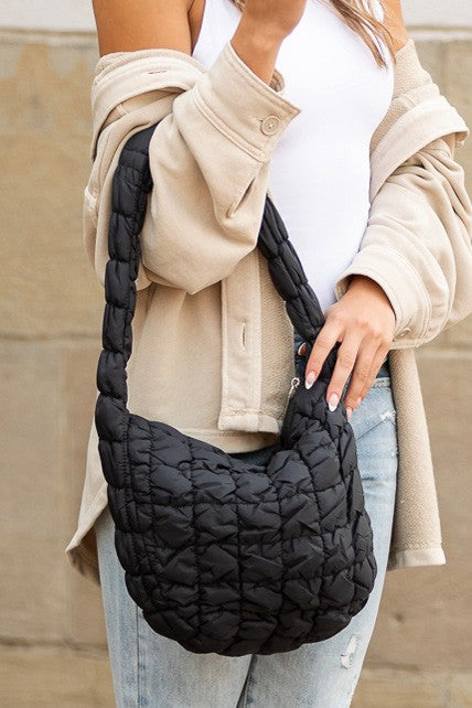 Shophouse Northwest black quilted puffer shoulder bag with braided strap and roomy crescent shape