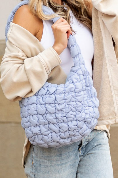Shophouse Northwest light blue quilted puffer shoulder bag with braided strap and soft quilted texture