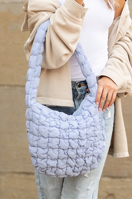 Shophouse Northwest light blue quilted puffer shoulder bag with braided strap and soft padded texture
