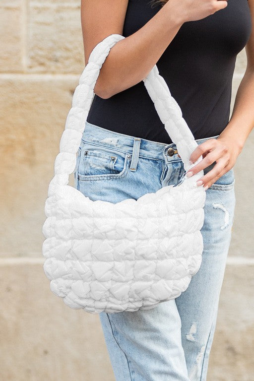 Shophouse Northwest white quilted puffer shoulder bag with padded handle and textured quilt stitching