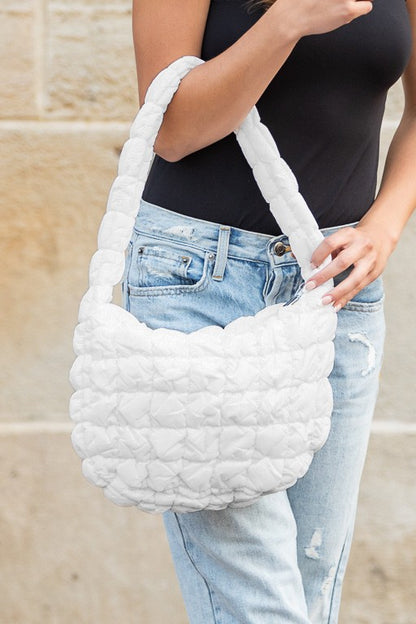 Shophouse Northwest white quilted puffer shoulder bag with padded handle and textured quilt stitching