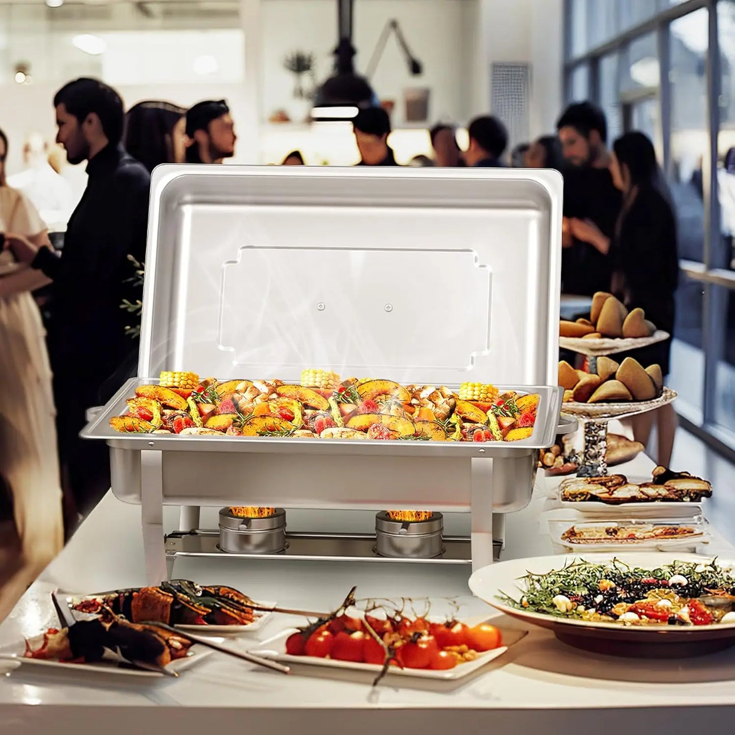 Stainless steel chafing dish buffet set displaying a variety of gourmet foods at a catering event