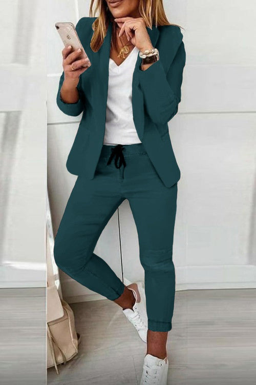 Stylish petrol blazer and trousers for women with a modern fit, paired with casual sneakers