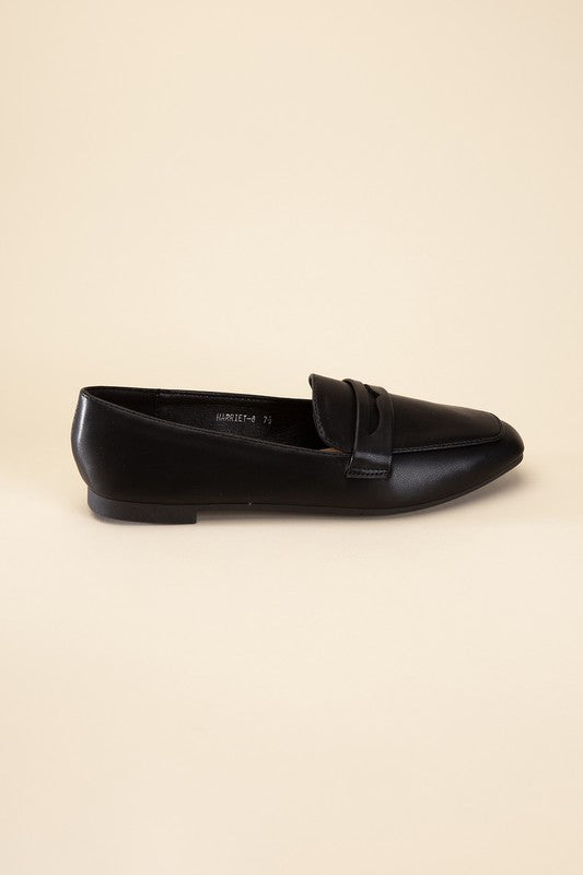 Shophouse Northwest black leather Harriet-8 slip on penny flats shoes side profile on beige